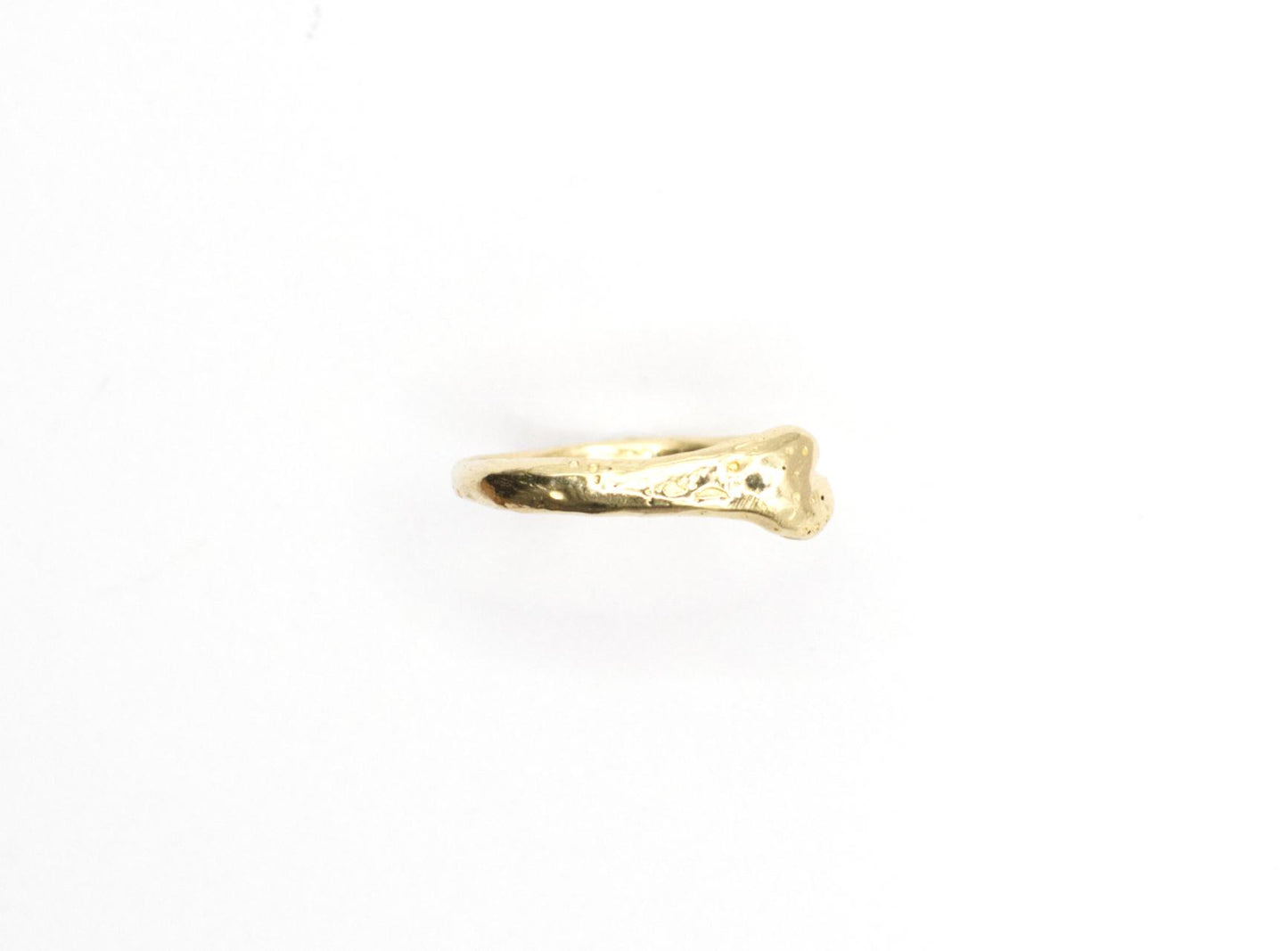 Gold bone ring on a white background