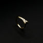 Gold ring with embedded stones on a black background