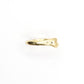 Gold bone ring on a white background